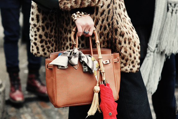 silk scarf tied onto leather bag