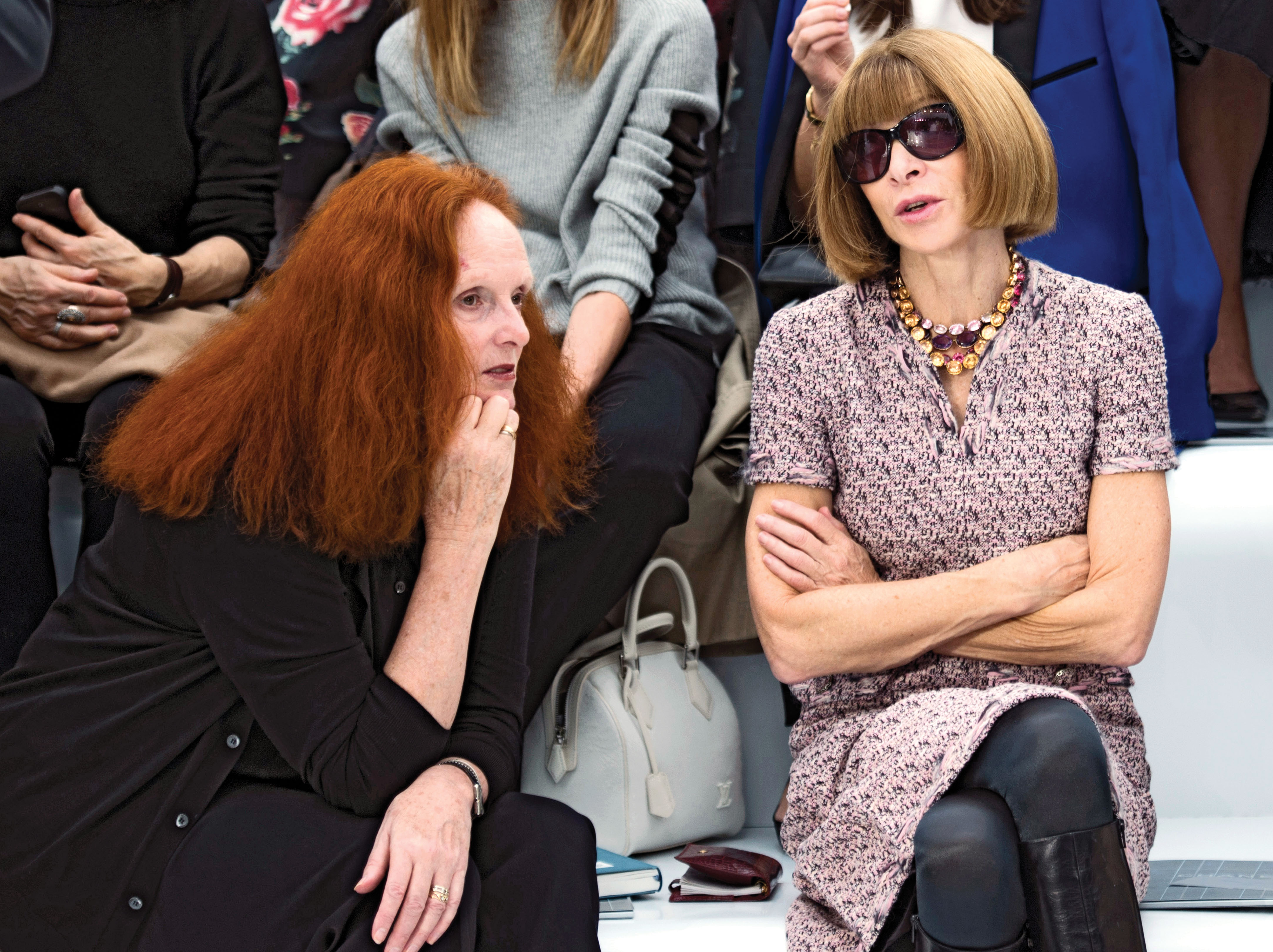 US Vogue's artistic director Grace Coddington (L) and US Vogue editor in chief Anna Wintour chat prior to the Chanel Spring/Summer 2013 ready-to-wear collection show on October 2, 2012 at the Grand Palais in Paris. AFP PHOTO/MARTIN BUREAU (Photo credit should read MARTIN BUREAU/AFP/GettyImages)